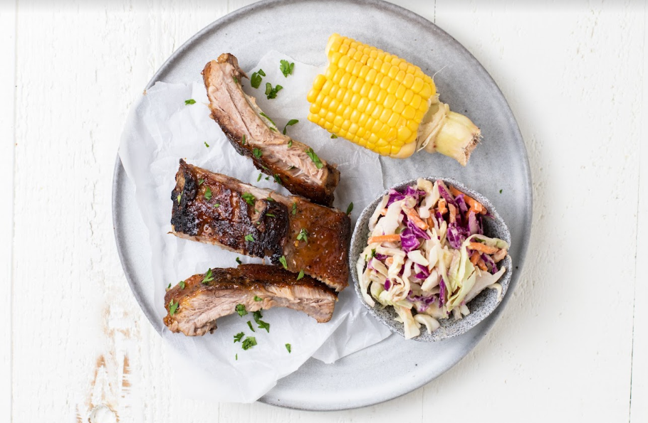 BBQ ribs, corn and coleslaw on a plate