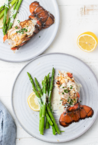 broiled lobster and asparagus on a plate