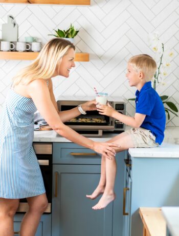 Woman sitting with child in kitchen
