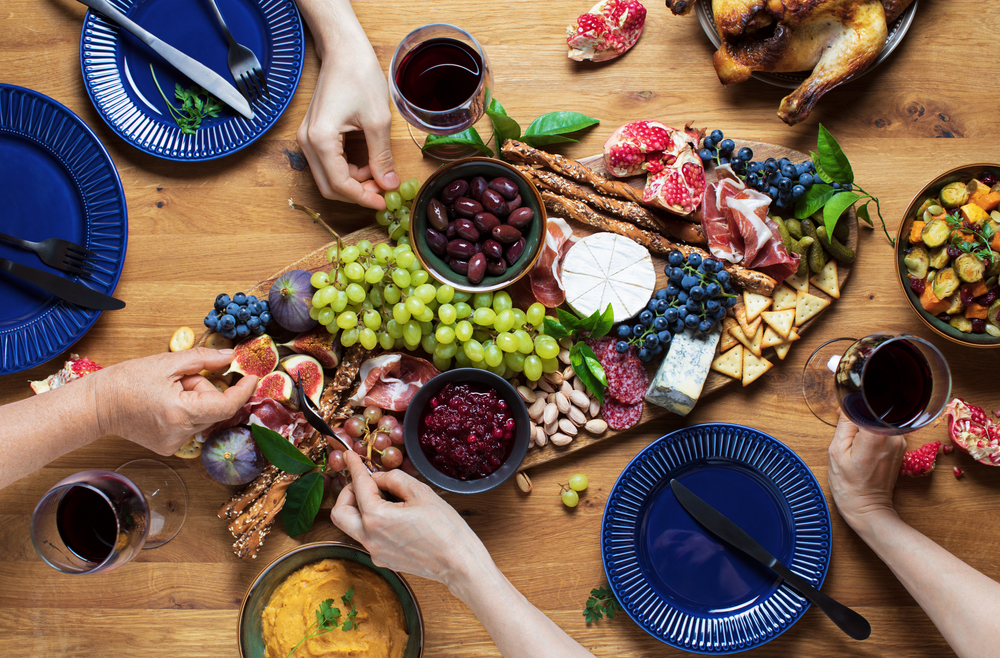 image of a charcuterie board with meat, cheeses, fruit and more on a table