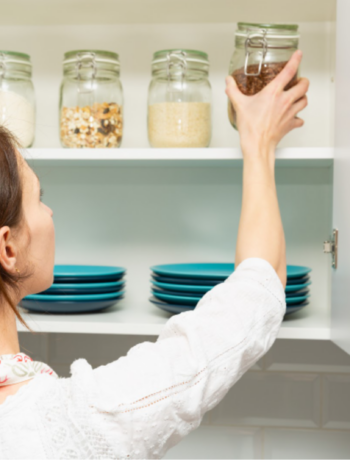 image of a person putting glasses away in their kitchen