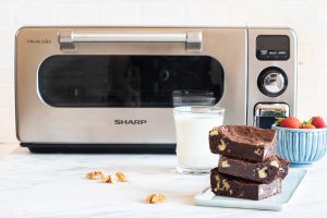 Vegan fudge brownies next to The Sharp Superheated Steam Countertop Oven (SSC0586DS).