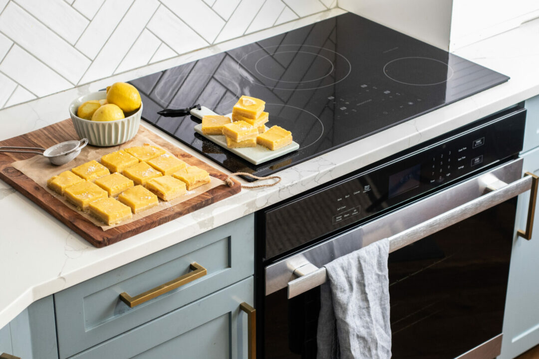 Lemon bars sitting on top of a 30 in. width Induction Cooktop, European Black Mirror Finish Made with Premium SCHOTT Glass (SDH3042DB).