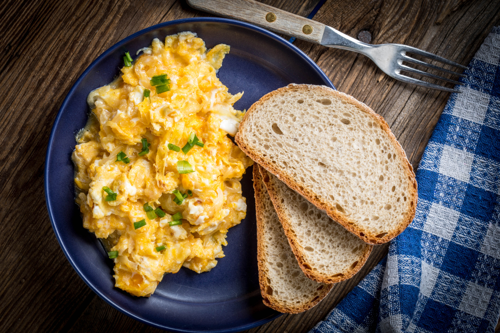 scrambled eggs with toast on a plate