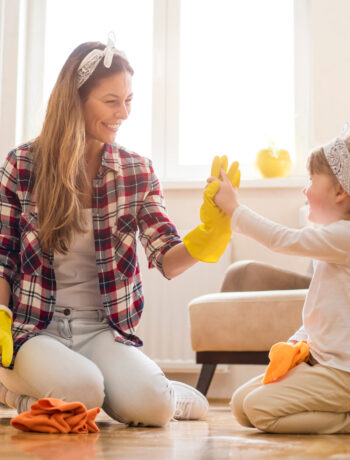 Woman and child cleaning in living room