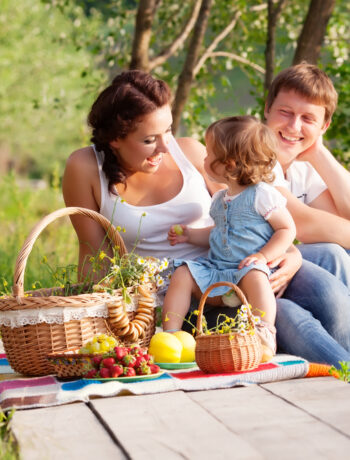 Family of three enjoying a picnic outdoors