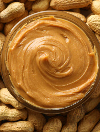 Peanuts and peanut butter in a jar for national peanut butter day on January 24th