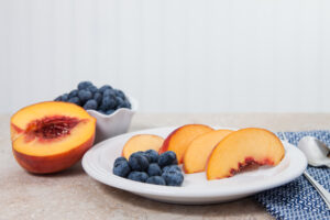 sliced peaches and blueberries on a dish