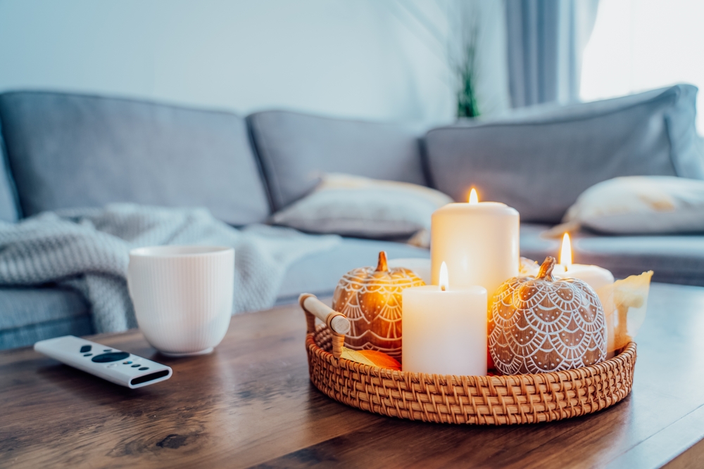 Cozy living room with candles and coffee and blankets