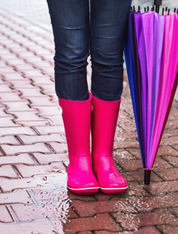 Colorful rainboots and umbrella in a rainy city