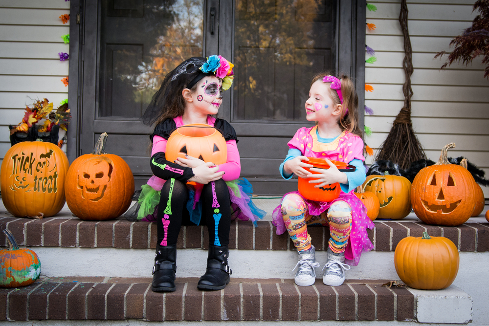 Children dressed up for Halloween on front porch