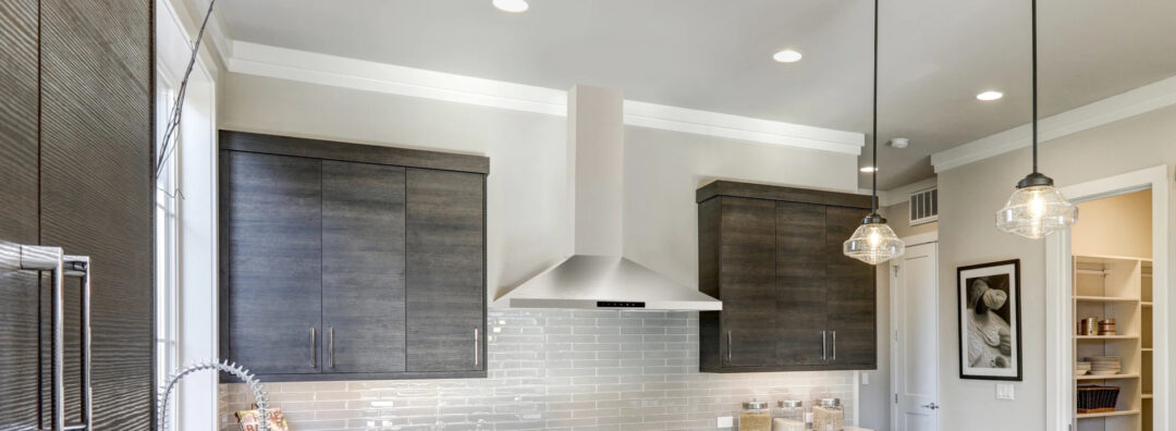 A 36 in. Wall Mount Chimney Range Hood (SHC3662FS) situated in a modern kitchen with brown accents.